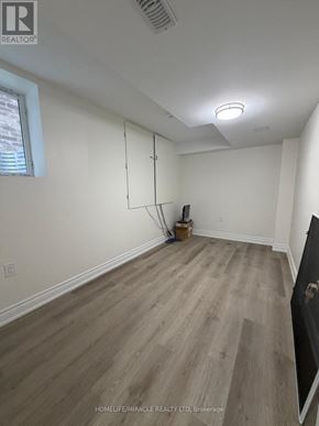Oshawa (Eastdale) apartment for rent - A room with wooden flooring and a ceiling light fixture.