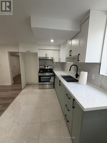 Oshawa (Eastdale) apartment for rent - A kitchen with white cabinets and a marble countertop.