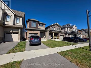 Brantford apartment for rent - A row of houses with cars parked in front.
