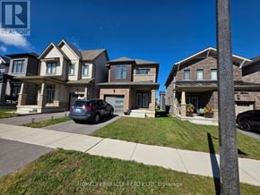 Brantford apartment for rent - A row of houses with a car parked in front of them.