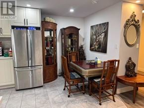 Toronto (Steeles) condo for rent - A kitchen with a table and chairs in the middle of the room.