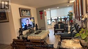 Toronto (Steeles) condo for rent - A living room with a flat screen TV and a sofa.