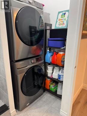 Toronto (Steeles) condo for rent - A washing machine is in a small laundry room.