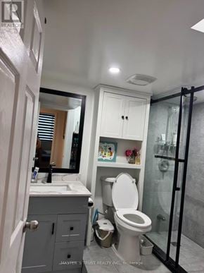 Toronto (Steeles) condo for rent - A bathroom with a toilet, sink, and mirror.