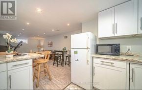 Oshawa (Mclaughlin) apartment for rent - A kitchen with white cabinets and a refrigerator.