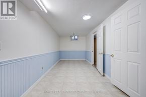 Markham (Milliken Mills West) apartment for rent - A hallway with white walls and a blue stripe on the wall.