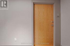Pickering (Bay Ridges) condo for rent - A wooden door with a number 1302 on it.