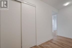 Pickering (Bay Ridges) condo for rent - A room with a sliding door and a wooden floor.