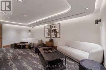 Pickering (Bay Ridges) condo for rent - A modern living room with a white couch and a coffee table.
