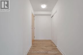 Pickering (Bay Ridges) condo for rent - A hallway with a door on the left and a light on the ceiling.