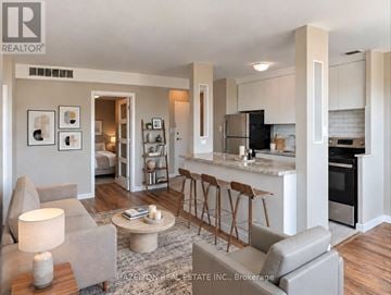 Toronto (Annex) condo for rent - A modern living room with a grey couch and a coffee table.