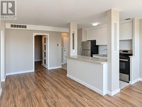 Toronto (Annex) condo for rent - A kitchen area with a refrigerator, oven, and microwave.