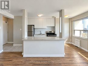 Toronto (Annex) condo for rent - A kitchen with a white island in the middle of the room.