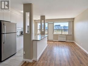 Toronto (Annex) condo for rent - A kitchen with a refrigerator and wooden floors.