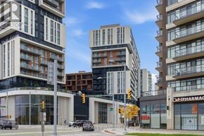 Markham (Unionville) condo for rent - A city street with buildings, cars, and traffic lights.