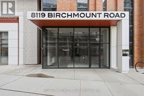 Markham (Unionville) condo for rent - The entrance to a building with a glass door and a sign that reads "8119 Birchmount Road".