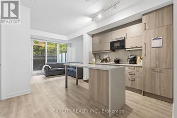 Markham (Unionville) condo for rent - A well-lit kitchen with wooden cabinets and a microwave above the stove.