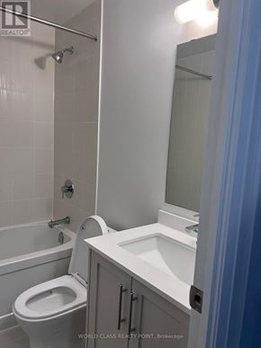 Vaughan (Beverley Glen) condo for rent - A white toilet is in a bathroom with a white sink.
