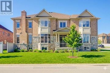 Bradford West Gwillimbury (Bradford) apartment for rent - A large, well-maintained house with a stone facade and a large front yard.