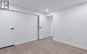 Thorold (Allanburg/Thorold South) apartment for rent - A white room with a door on the left and two open doors on the right.