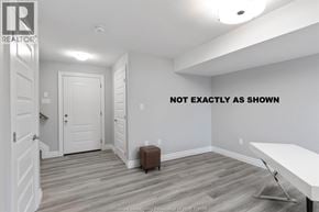 Lakeshore townhouse for rent - A room with a white table and a brown ottoman.