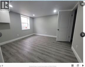 Windsor apartment for rent - A room with wooden flooring and a door on the right side.