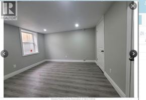 Windsor apartment for rent - A room with wooden flooring and white walls.