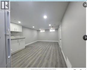 Windsor apartment for rent - A spacious room with wooden flooring and white walls.