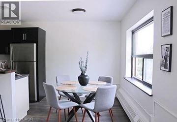 Kitchener apartment for rent - A dining room with a glass table and chairs.