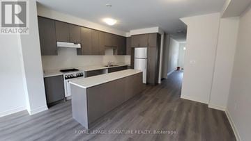 Cambridge townhouse for rent - A kitchen with a counter top and cabinets.