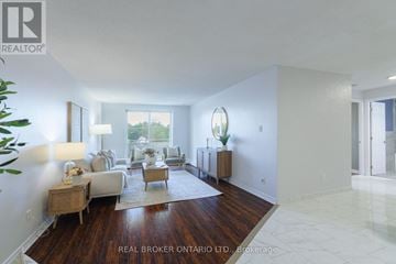 Hamilton (Raleigh) condo for rent - A well-lit, spacious living room with a white couch and a wooden floor.