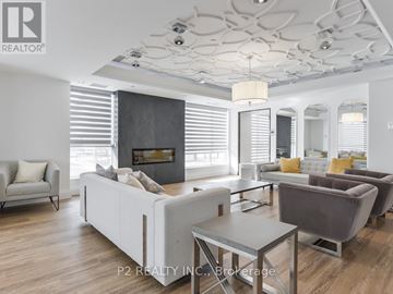 Markham (Wismer) condo for rent - A modern living room with a grey sofa set and a fireplace.