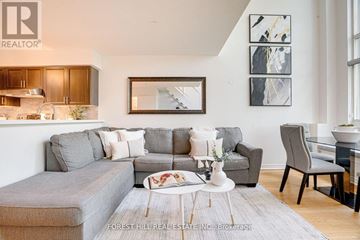 Toronto (Mimico) condo for rent - A living room with a grey couch and a coffee table.