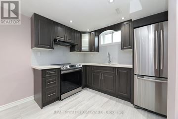 Toronto (Kennedy Park) apartment for rent - A modern kitchen with dark wood cabinets and stainless steel appliances.