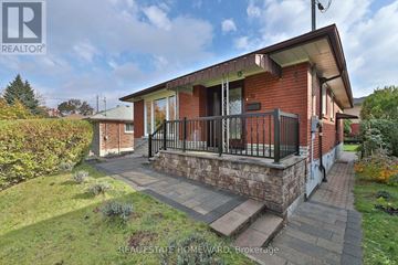 Toronto (Kennedy Park) apartment for rent - A red brick house with a balcony and a small garden in front.