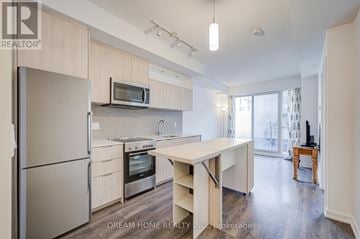 Toronto (Henry Farm) condo for rent - A modern kitchen with a refrigerator, microwave, oven, and sink.