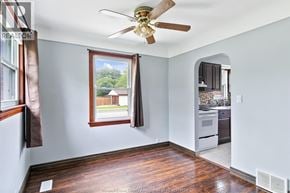 Windsor apartment for rent - A room with a ceiling fan and a window overlooking a backyard.