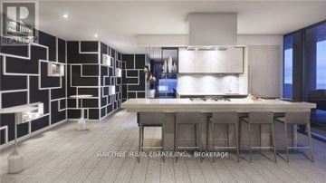 Toronto (Mount Pleasant West) condo for rent - A modern kitchen with a dining table and bar stools.