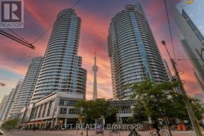 Toronto (Waterfront Communities) condo for rent - A cityscape with buildings and a street in front.