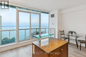 Toronto (Waterfront Communities) condo for rent - A room with a glass table and chairs with a view of the water.