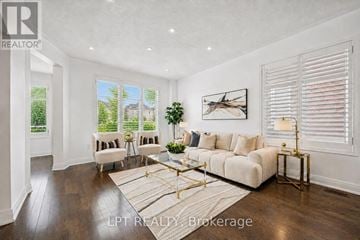 Toronto (Cliffcrest) apartment for rent - A well-lit living room with a white sofa and a coffee table.