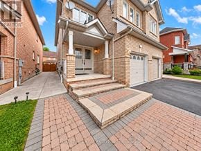Vaughan (Vellore Village) apartment for rent - A large house with a brick driveway and a garage.