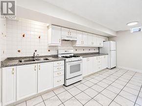 Vaughan (Vellore Village) apartment for rent - A white kitchen with tile flooring and white cabinets.