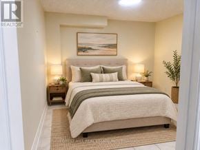 Vaughan (Vellore Village) apartment for rent - A bedroom with a bed, nightstands, and a painting on the wall.