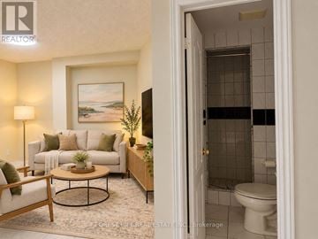 Vaughan (Vellore Village) apartment for rent - A living room with a couch, a coffee table, and a painting on the wall.
