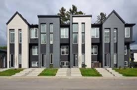 Calgary apartment for rent - A row of modern houses with grey and white exteriors.