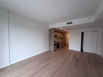 Vancouver apartment for rent - A room with wooden flooring and white walls.