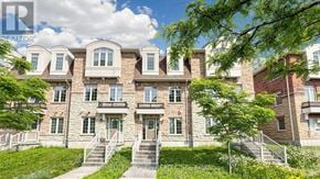 Markham (Victoria Square) townhouse for rent - A large, multi-story residential building with a front porch and stairs leading up to the entrance.