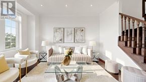 Markham (Victoria Square) townhouse for rent - A living room with a glass coffee table and a staircase.