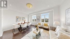 Markham (Victoria Square) townhouse for rent - A well-lit, spacious living room with a dining table set for six.
